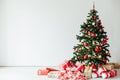 Christmas tree with gifts of red white interior decor for the new year Royalty Free Stock Photo