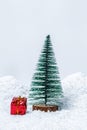 Christmas tree with gifts in snow drift. Free space for your text