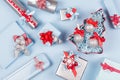 Christmas tree with glitter balls and gift boxes, decorations in pastel blue and silver metallic color with red silk ribbons. Royalty Free Stock Photo