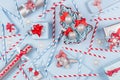 Christmas tree with glitter balls and gift boxes, decorations, straws in pastel blue and silver metallic color with red ribbons. Royalty Free Stock Photo