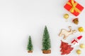 Christmas tree, gold balls, snowman, reindeer, pine cone and gift boxes on white background.