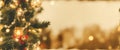 Christmas Tree With gold Baubles close-up against backdrop of golden sparkling Christmas lights. Wide format banner. AI Generated Royalty Free Stock Photo