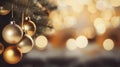 Christmas Tree With gold Baubles close-up against backdrop of golden sparkling Christmas lights. Wide format banner. Royalty Free Stock Photo