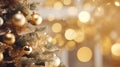 Christmas Tree With gold Baubles close-up against backdrop of golden sparkling Christmas lights. Wide format banner Royalty Free Stock Photo