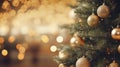 Christmas Tree With gold Baubles close-up against backdrop of golden sparkling Christmas lights. Wide format banner. Royalty Free Stock Photo