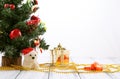 Christmas tree, gold gift box, balls, toy bear, candies and decorations on retro vintage white table isolated Royalty Free Stock Photo