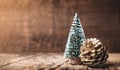 Christmas tree and gold pine cone on grunge wood table and dark brown wooden wall.Winter Merry Christmas holiday greeting card Royalty Free Stock Photo