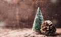 Christmas tree and gold pine cone and snow falling on grunge woo Royalty Free Stock Photo