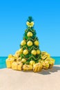 Christmas tree with golden decorations at hot tropical ocean beach Royalty Free Stock Photo