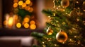 Christmas tree with golden ornaments on bokeh background.