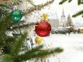 Christmas tree green branch red ball gold confetti and yellow gareet ,lantern light blurred in shop windows vitrines , night sky f Royalty Free Stock Photo