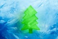 Christmas tree green ice shape on blue frozen background, 3d render Royalty Free Stock Photo