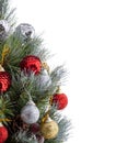 Christmas tree. Green pine branches decorated with bright red, golden, silver balls, cones and red berries. Tips of pine twigs Royalty Free Stock Photo