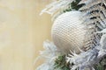 Christmas tree with holiday silver ball and lights with copy space on blurred bokeh background in interiors. Close up. Royalty Free Stock Photo