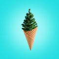 Christmas tree with ice cream cone on bright background. Winter holiday concept