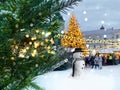 Christmas tree illuminated snow flakes festive bokeh light snowman on Town hall square in Tallinn Estonia