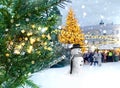 Christmas tree illuminated snow flakes festive bokeh light snowman on Town hall square in Tallinn Estonia