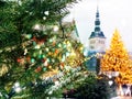 Christmas tree illuminated snow flakes festive bokeh light snowman on Town hall square in Tallinn Estonia