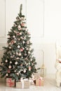 Christmas tree indoors with light and roses Royalty Free Stock Photo