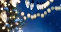 art Christmas Tree light over Snowy dark blue sky background Royalty Free Stock Photo