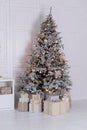 Christmas tree with lights glowing garlands and gifts. Festive interior design living room with a Christmas tree and decorations. Royalty Free Stock Photo