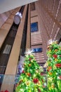 Christmas tree lights inside a modern building with elevators. H