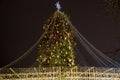 Christmas tree with lights outdoors at night in Kiev. Sophia Cathedral on background. New Year Celebration