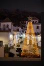 Simple Christmas tree lights in the village plaza, Sedella, Spain. Royalty Free Stock Photo