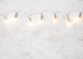 Christmas tree lights on white shabby background. Royalty Free Stock Photo