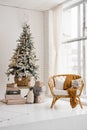 Christmas tree in the living room in bright colors, a chair from the rotunda