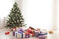 Christmas tree lots of gifts in a bright room Royalty Free Stock Photo