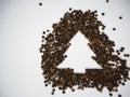 Christmas tree made of black peppercorns on a white background