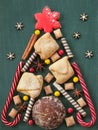 Christmas tree made of cookies and sweets on a wooden table. Royalty Free Stock Photo