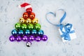 Christmas tree made of decorations balls LGBT community rainbow flag colors, Santa Claus hat, gift box, blue ribbon shape of heart