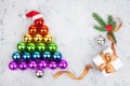 Christmas tree made of decorations balls LGBTQ community rainbow flag colors, Santa Claus hat, gift box and ribbon, red heart Royalty Free Stock Photo