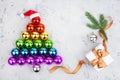 Christmas tree made of decorations glass balls LGBTQ community rainbow flag colors, Santa Claus hat, gift box, fir branch Royalty Free Stock Photo