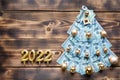 Christmas tree made of 100 dollar bills and House key, candles with the numbers 2022. Christmas decor of finance, savings, wealth Royalty Free Stock Photo