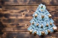 Christmas tree made of 100 dollar bills on wooden background with copyspace. Christmas decor on theme of finance, savings, wealth Royalty Free Stock Photo