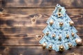 Christmas tree made of 100 dollar bills on wooden background with copyspace and House key. Christmas decor of finance, savings, Royalty Free Stock Photo