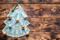 Christmas tree made of 100 dollar bills on wooden background with copyspace and House key. Christmas decor of finance, savings, Royalty Free Stock Photo