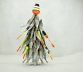 This Christmas tree is made of dried fish. New year for the fisherman. The tree is decorated with floats and fishing tackle. The