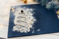 Christmas tree made from flour on the black on shale food board background with badonia stars and cinnamon sticks Royalty Free Stock Photo