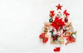 Christmas tree made from Christmas gifts and decorations on white background. Creative winter holiday concept. Flat lay Royalty Free Stock Photo