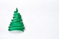 Christmas tree made from green ribbon on white background.