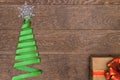 Christmas tree made of green ribbon on a wooden background