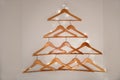 Christmas tree made of hangers. DIY wall decoration.