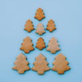 Christmas tree made of homemade shortbread cookies on light blue background. Royalty Free Stock Photo