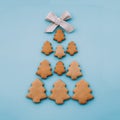 Christmas tree made of homemade shortbread cookies with ribbon on light blue background Royalty Free Stock Photo