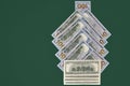 Christmas tree made from hundred dollar bills on green background. Copy space. Top view. New Year celebration concept, creative. Royalty Free Stock Photo