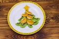 Christmas tree made of kiwi slices and mandarin lobules on wooden table. Top view. Creative idea for Christmas and New Year Royalty Free Stock Photo